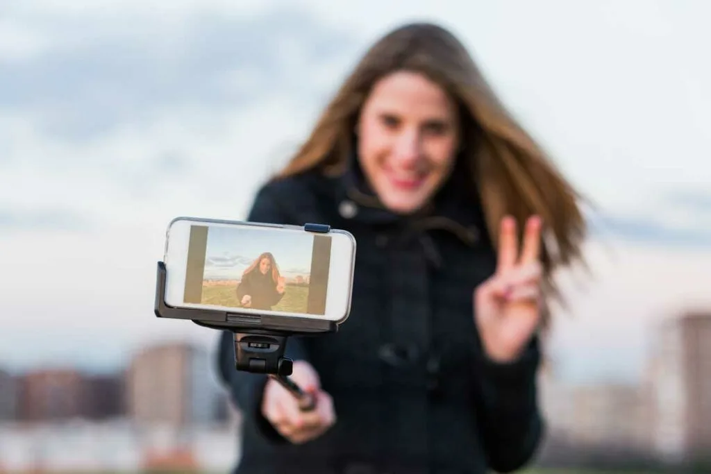 Woman taking photos or recording a video on smartphone