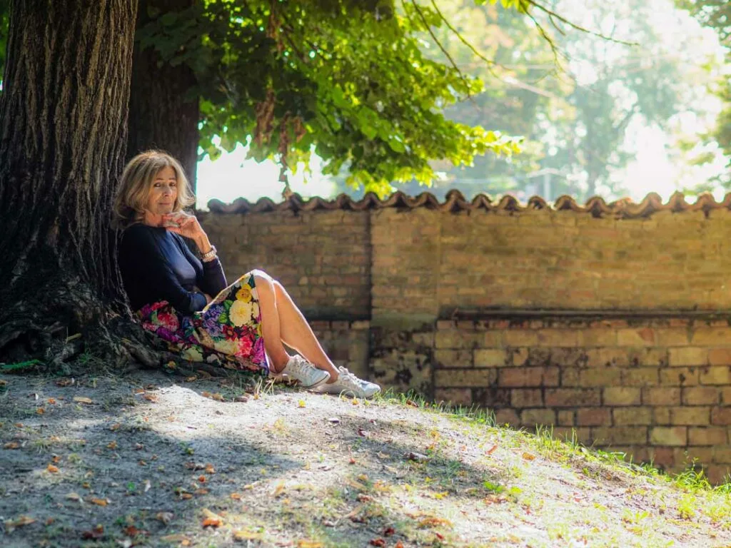 woman sitting in shade outside