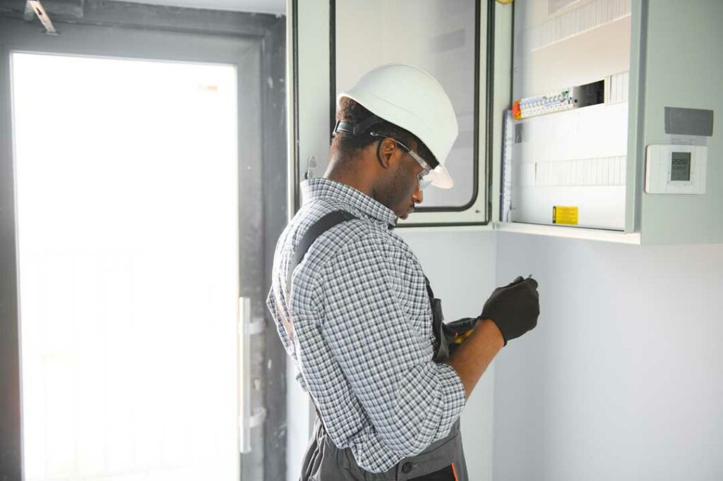 Emergency electrician checking home electrical panel