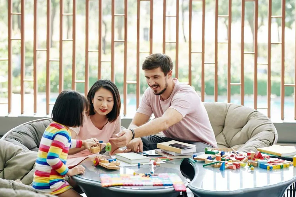Family playing money games to teach preschoolers about money