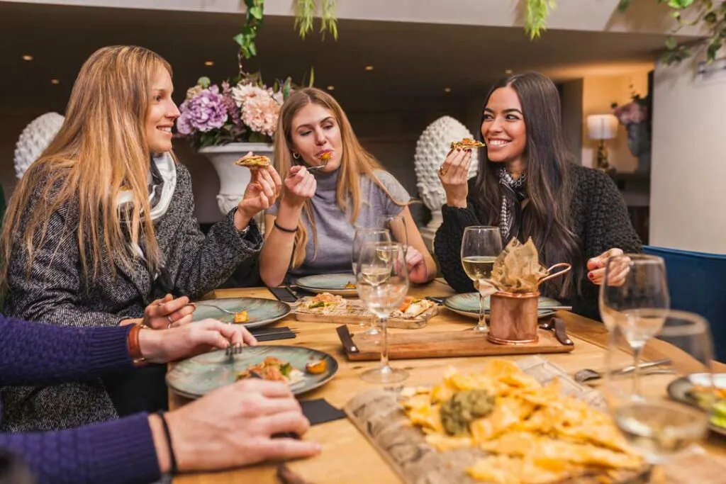 Group enjoying food at private restaurant soft opening