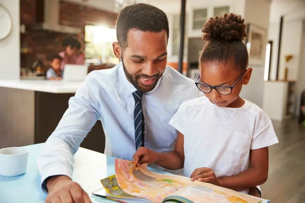 Parent teaching preschooler about money through children’s books