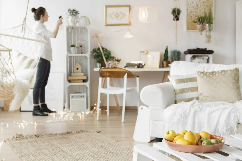 Cleaning professional wiping furniture in a clean, cheerful room