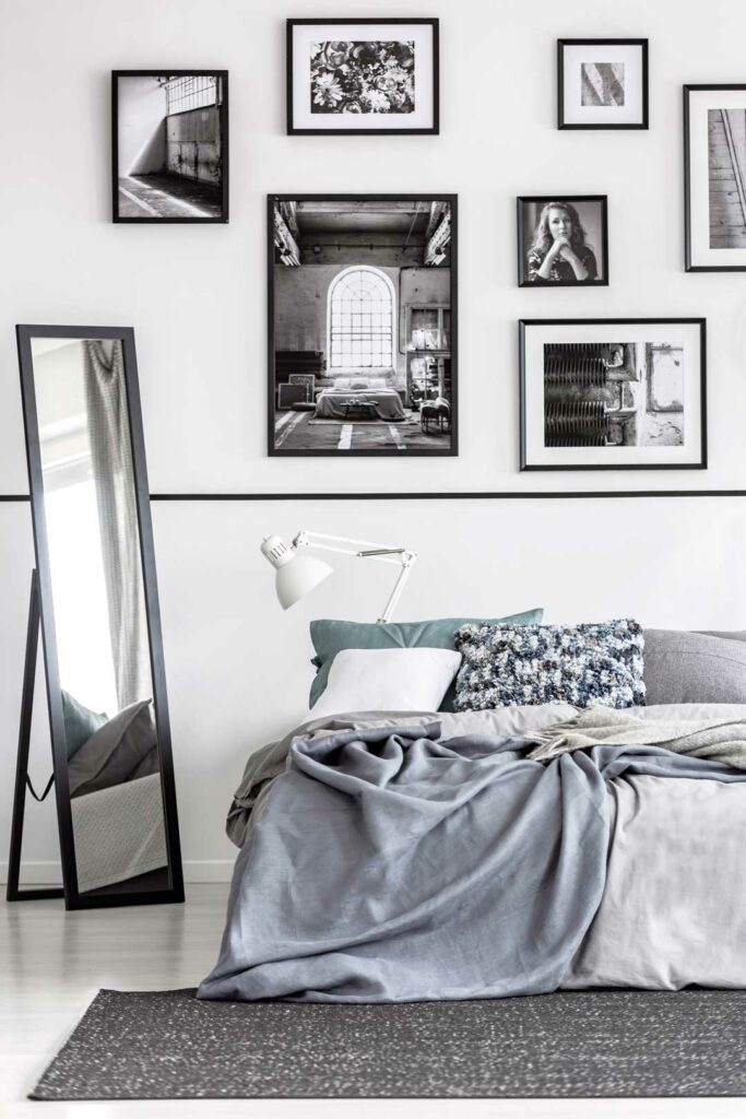 Small room with mirrors and framed artwork enhancing depth