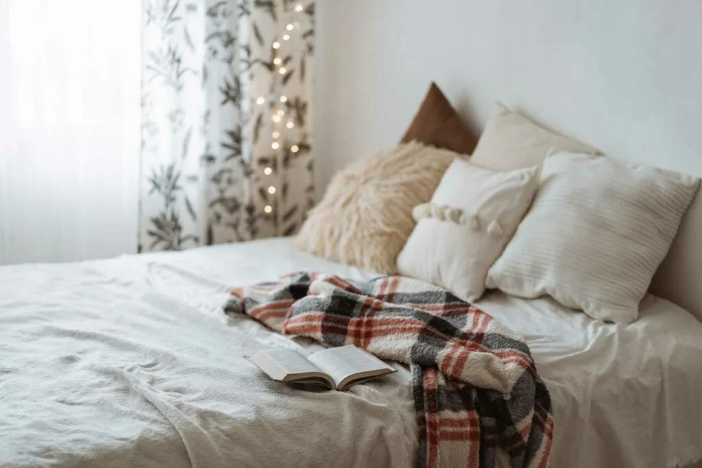 Cozy dorm room with layered textiles and soft decor accents