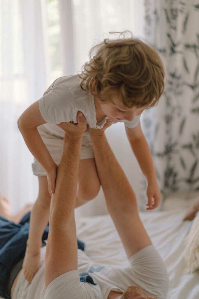 A parent bending properly to lift a toddler
