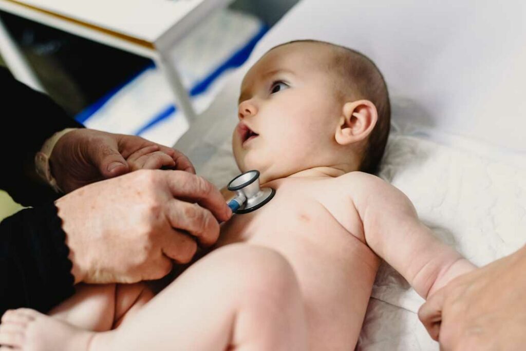 Doctor examining baby after slip and fall injury