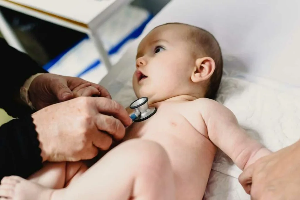 Doctor examining baby after slip and fall injury