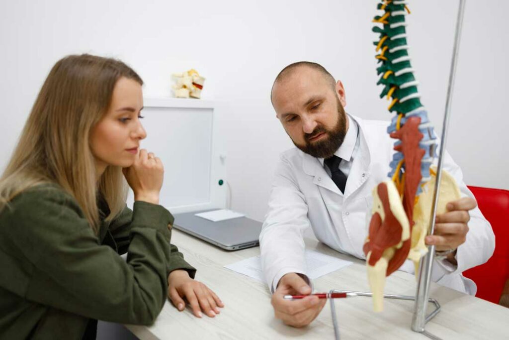 Specialist discussing spine disc treatments with a patient