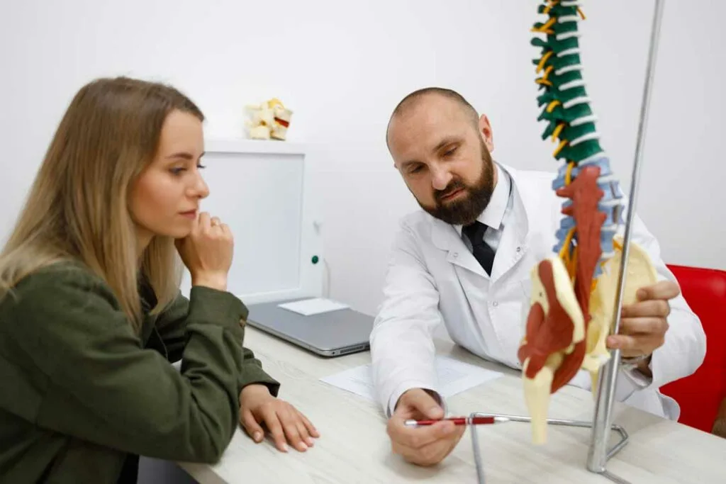 Specialist discussing spine disc treatments with a patient