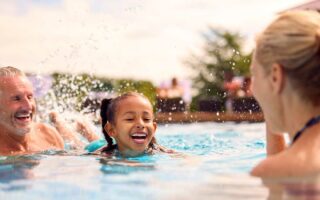 Children enjoying outdoor swimming with safer pool air quality