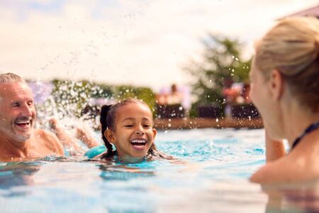 Children enjoying outdoor swimming with safer pool air quality
