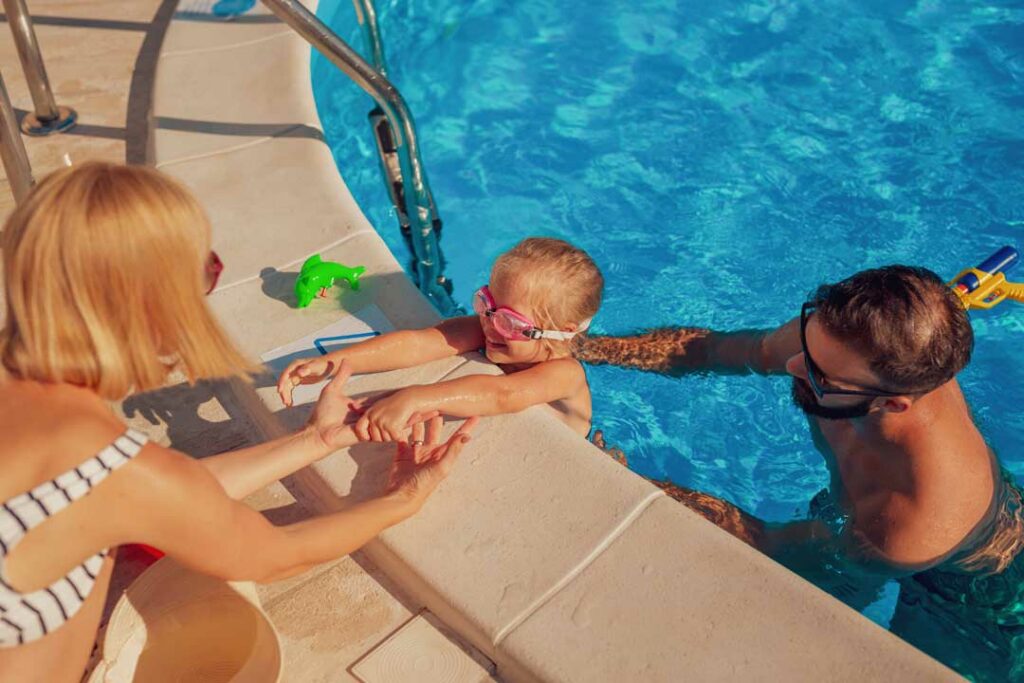 Parent preparing child for safe swimming with health precautions